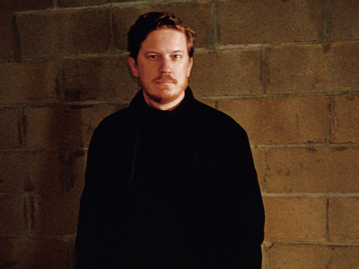 Filip Niedenthal Vogue Editor In Chief Poland Brick wall brown Black Turtleneck Portrait
