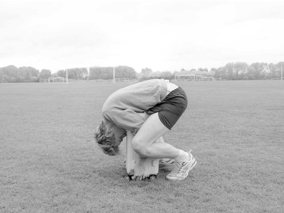 pride and commerce rimowa black white photo man gymnastics