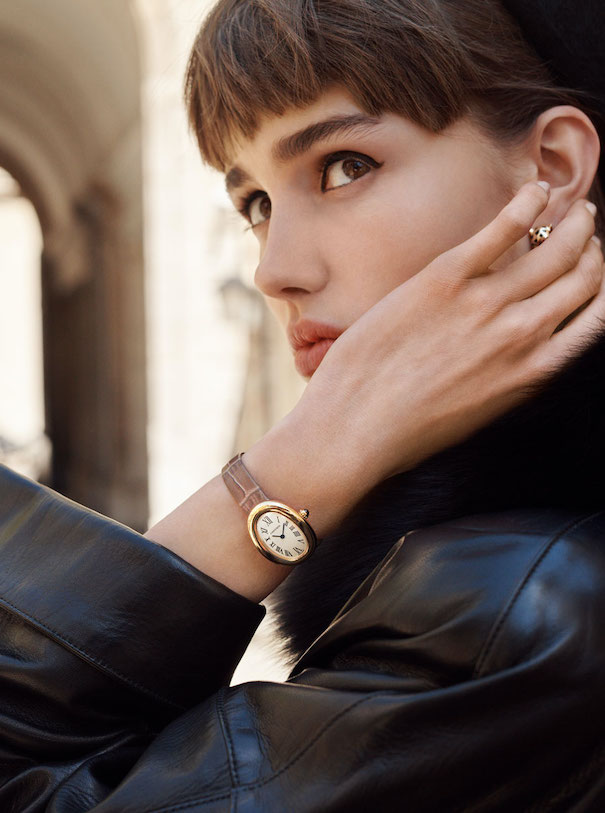 cartier watch woman bangs brown hair black coat