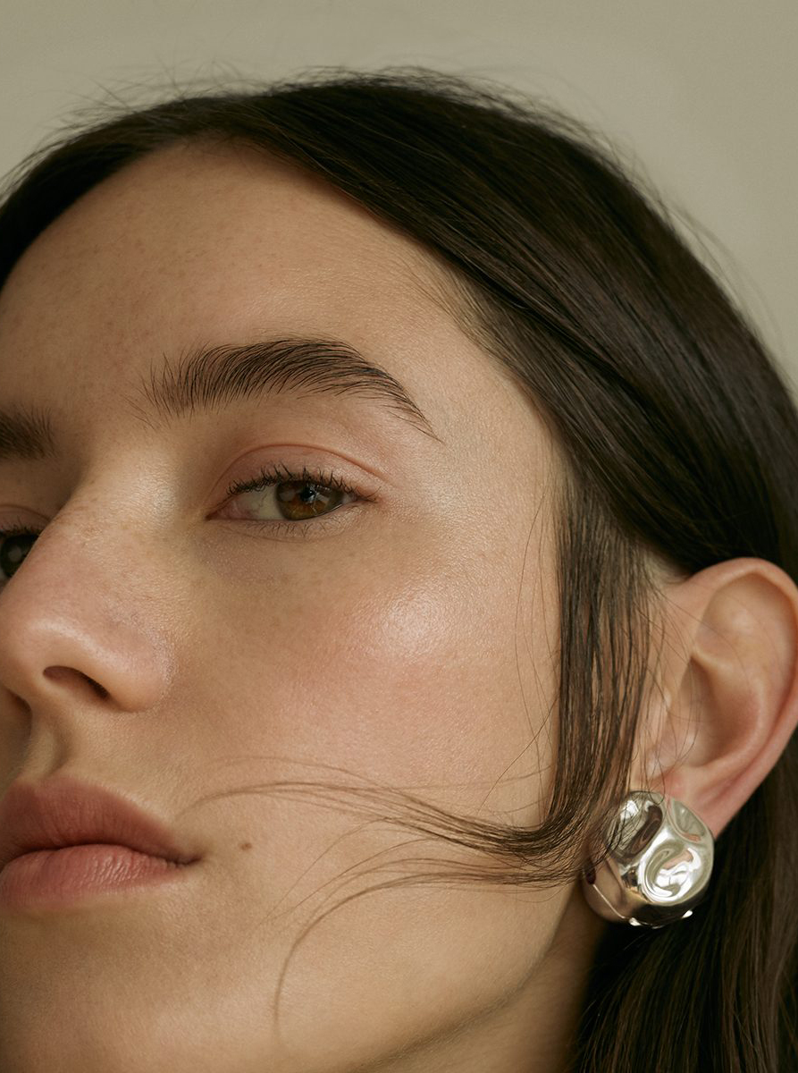 model brown hair highlighter earring portrait