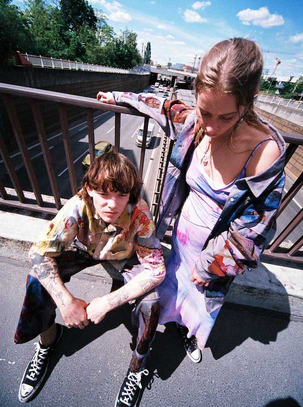 julia seemann flavio zimmermann two models man sitting woman standing road fence