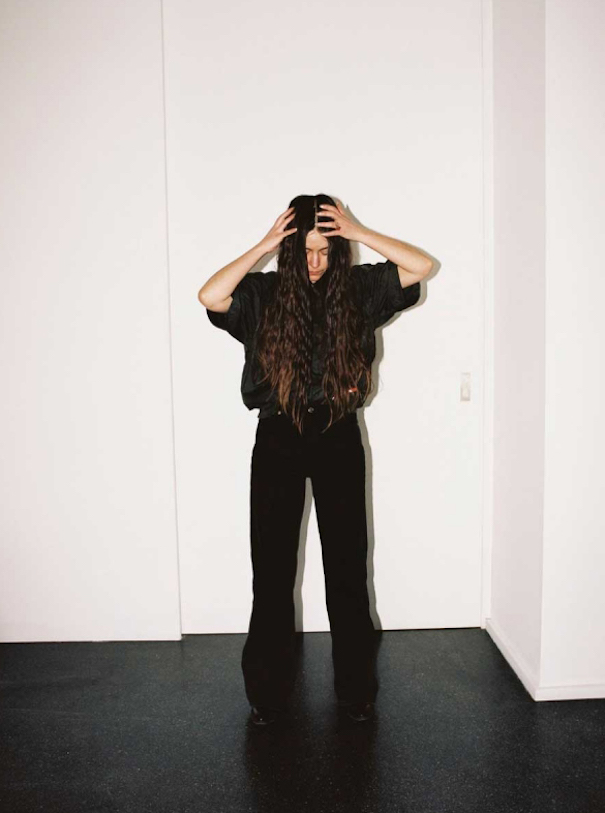andra dumitrascu protrait black floor jeans long brown hair