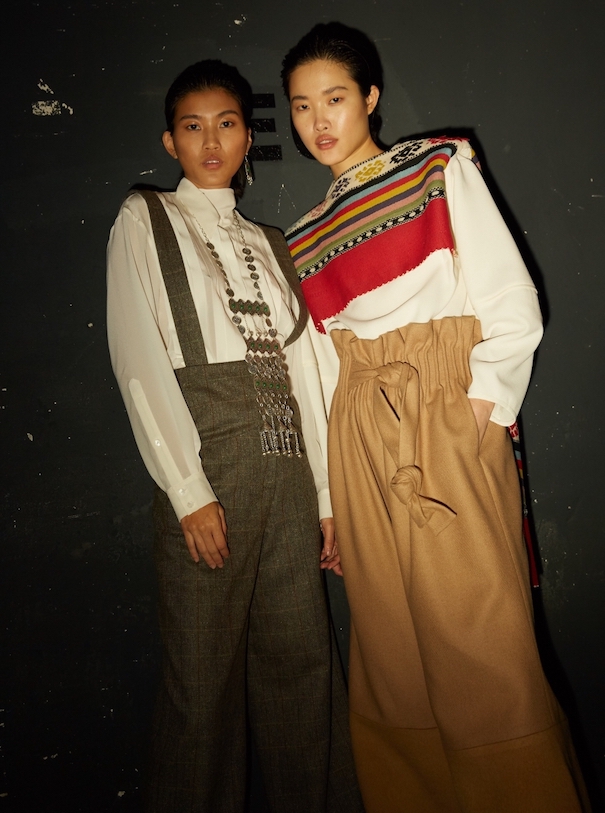Nobieh Talei Campaign Two Models Pants Suit Sweater Red Brown Beige Black Background