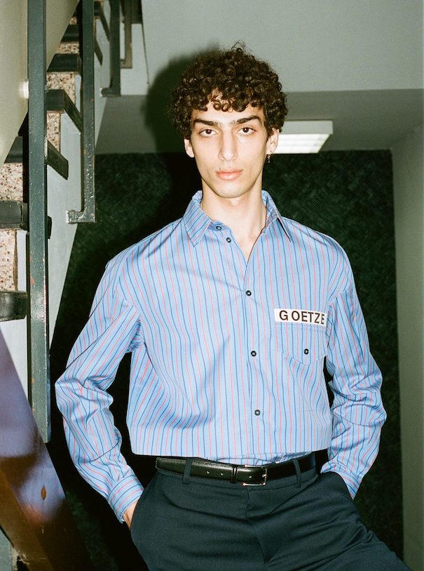 Sissi Goetze Model Blue striped shirt hallway stairs