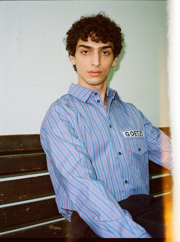 Sissi Goetze Model Blue striped shirt hallway stairs