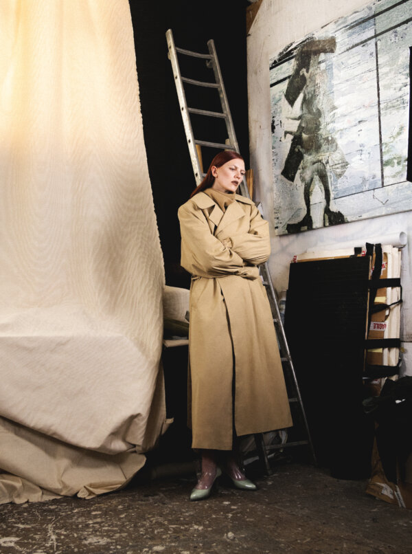 Ella Loudon wearing Trenchcoat and top VAUTRAIT; Shoes RABANNE; Bracelets and rings THIBAULT HAZELZET