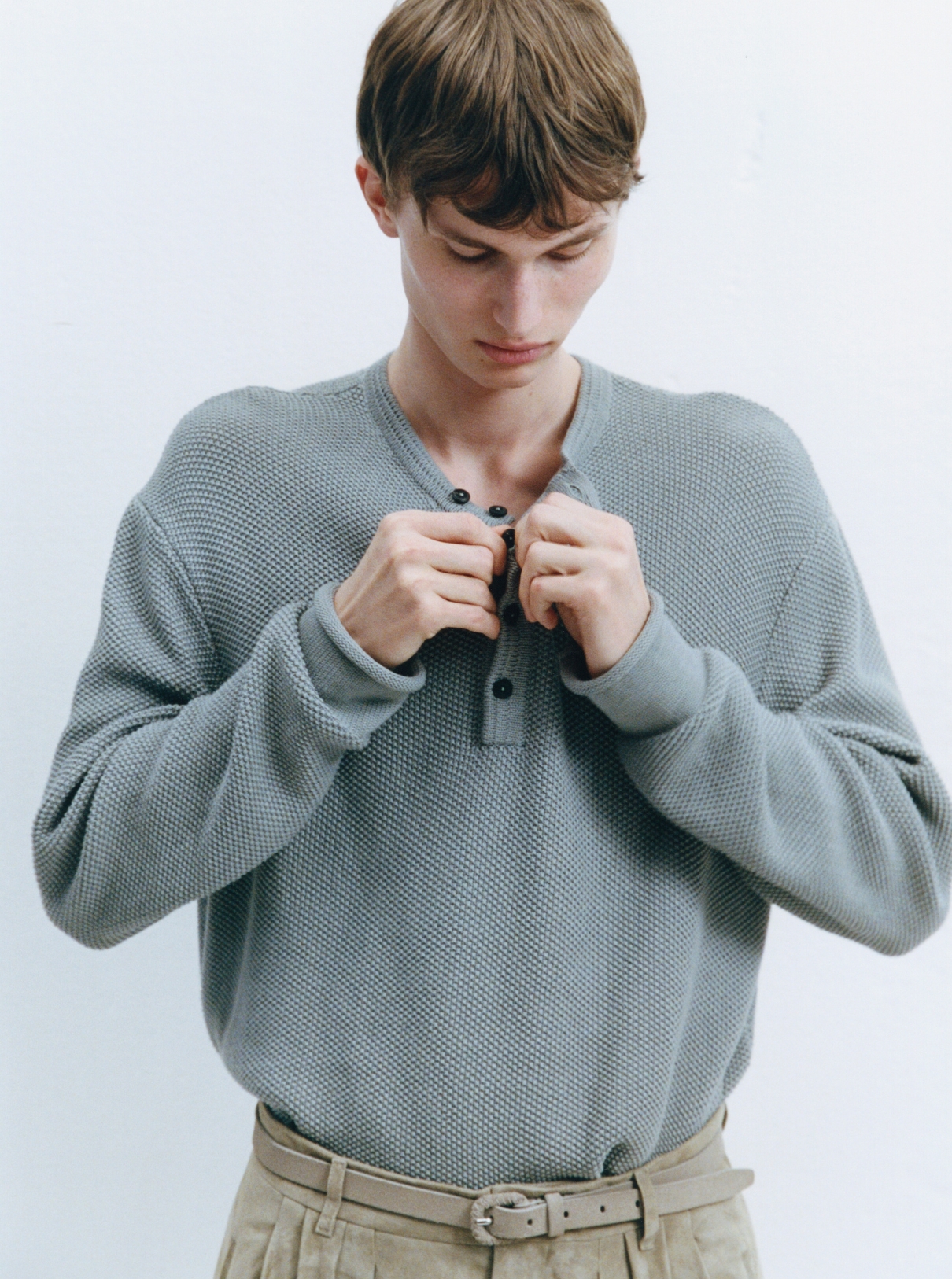 Male model dressing for ACHTUNG 51 behind the scenes shoot